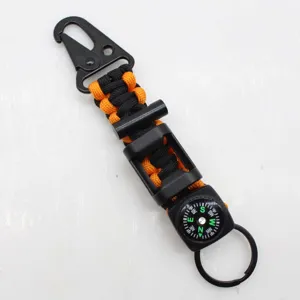 Multi-functional outdoor survival paracord keychain with compass and fire starter tool.