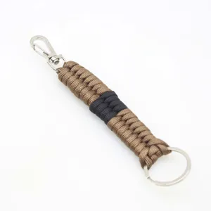Close-up of handmade paracord keychain detail with durable woven brown and black nylon rope.