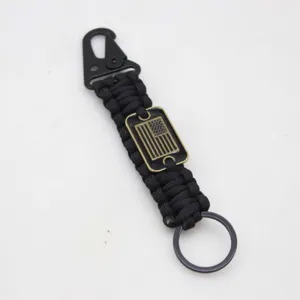 Detailed view of outdoor survival paracord keychain with eagle hook and US flag metal tag.
