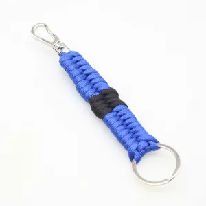 Paracord keychain detail showing blue and black hand-woven nylon rope with metal hardware.