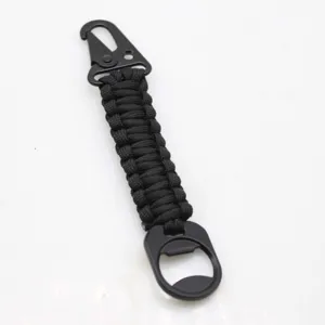 Tactical paracord keychain with carabiner and bottle opener, black outdoor gear accessory.