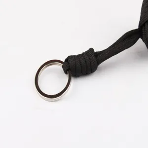 Close-up detail shot of black paracord keychain showing braided rope structure and metal ring.