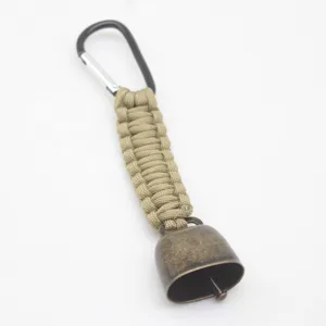 Outdoor camping bear bell with khaki paracord and metal carabiner keychain clip for hiking.