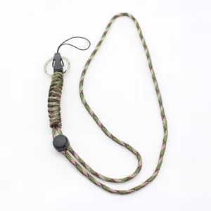 Detailed view of camo paracord lanyard with metal key ring and adjustable buckle.