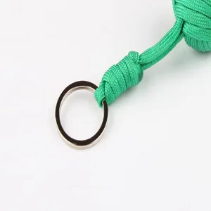Close-up detail shot of green paracord woven keychain lanyard featuring a sturdy metal ring.