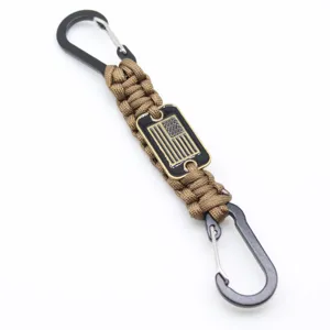 Paracord lanyard keychain with US flag metal badge and carabiner clips for outdoor survival.