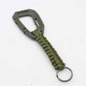 Green paracord keychain with plastic carabiner and metal ring for outdoor backpack use.