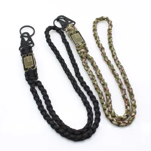 Close-up detail of durable outdoor paracord lanyard with metal eagle-beak clasp and key ring.