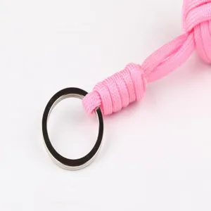 Pink paracord keychain monkey fist with steel ball, durable outdoor EDC survival gear.