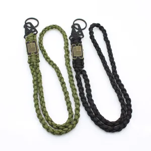 Outdoor paracord lanyard detail, braided cord with metal eagle clip and flag tag for camping.
