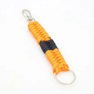 Paracord keychain detail showing orange and black woven nylon cord with silver metal hook.