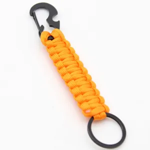 Detail view of the orange paracord keychain featuring a black metal bottle opener carabiner.