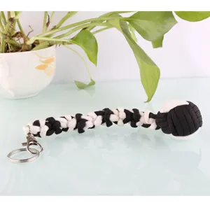 Handmade paracord keychain with metal ring and black white woven steel ball pendant detail.