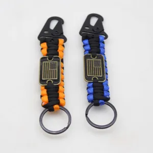 Paracord keychain survival gear with eagle beak buckle and American flag metal plate design.