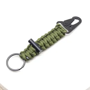 Green paracord keychain with metal carabiner and survival fire starter tool for outdoor