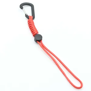 Outdoor tactical paracord keychain with black carabiner and red braided rope for camping.
