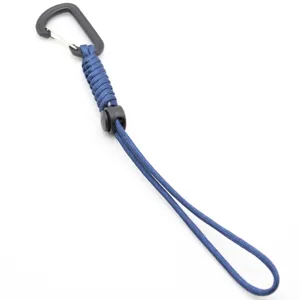 Paracord lanyard detail showing blue woven rope, black carabiner and adjustable buckle.