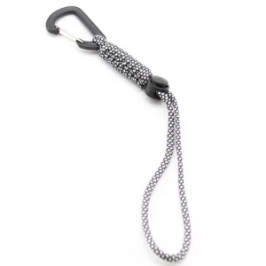 Closeup detail of black and white paracord lanyard with plastic carabiner clip, outdoor gear.