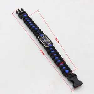 Paracord survival bracelet with metal tactical buckle and emergency blue line flag badge.
