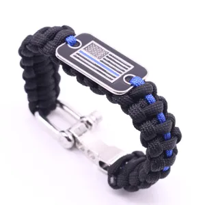 Survival paracord bracelet with black braided rope, blue line flag metal dog tag, and shackle clasp.