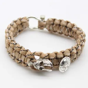 Spartan paracord survival bracelet detail view, showing the warrior helmet charm and shackle.