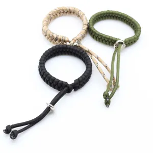 Close-up detail of handmade adjustable paracord survival bracelets in three color options.