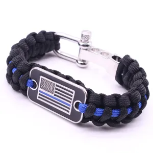Black paracord survival bracelet with metal shackle and blue line flag metal tag for men.