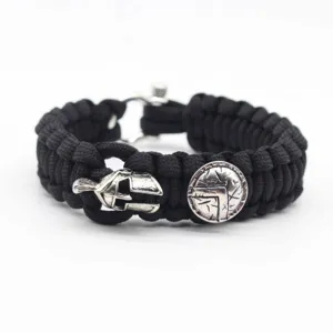 Detailed close-up view of the black paracord survival bracelet with silver Spartan helmet.