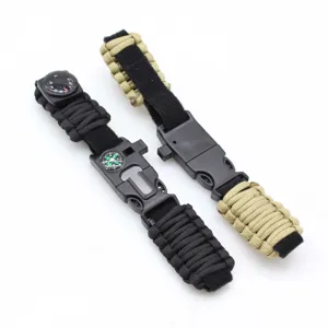 Outdoor survival paracord bracelet detail showing buckle and compass design for camping.