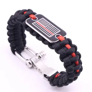 Detailed view of handmade paracord survival bracelet with metal flag tag and adjustable shackle.