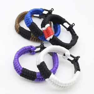 Detailed view of handmade paracord survival bracelets with alloy shackles, perfect for outdoor use.