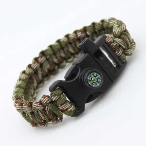 Close-up view of the woven paracord survival bracelet detailing the compass and durable black buckle.