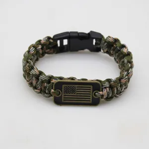 Handmade seven-core paracord survival bracelet with metal flag tag and plastic buckle.