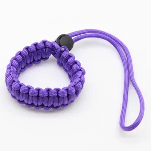 Purple paracord wrist strap, durable braided lanyard for camera and outdoor survival gear.