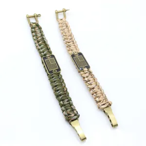 Outdoor survival paracord bracelet with zinc alloy shackle and American flag metal tag.