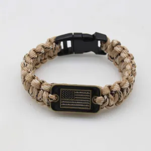 Detailed view of the paracord bracelet metal buckle and american flag emblem design.