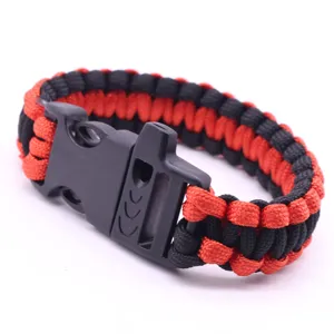 Red and black paracord survival bracelet featuring plastic whistle side release buckle for outdoor