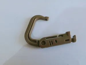 Plastic carabiner buckle detail shot, outdoor webbing clip accessory in khaki color.