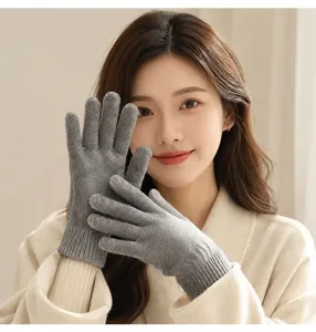 Close-up detail of women's solid grey knitted winter gloves, warm fleece-lined wool fabric.
