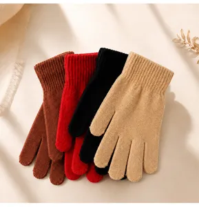 Detail view of soft knitted winter gloves in assorted colors, showing fine texture and warm fabric.