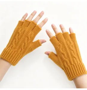 Detail view of winter warm half-finger knit gloves in mustard yellow, cable knit design.