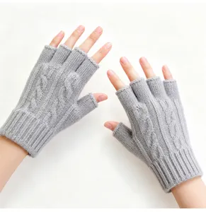 Detailed view of grey knitted fingerless gloves, offering warmth and dexterity for typing.