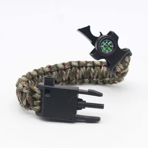 Multifunctional survival paracord bracelet with compass whistle and fire starter for camping use.