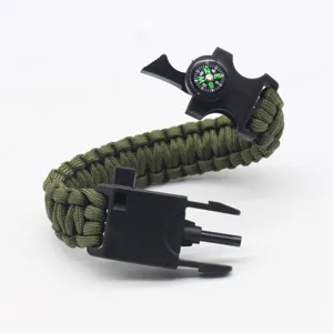 Outdoor survival paracord bracelet with compass, fire starter and scraper for camping.