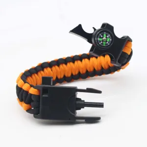 Multi-functional outdoor survival paracord bracelet with compass, whistle, and flint.