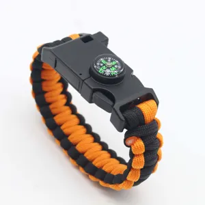 Close-up detail of the black and orange paracord survival bracelet with built-in compass buckle.