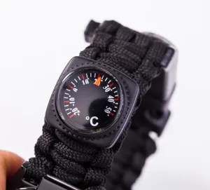 Close-up of survival paracord bracelet showing built-in thermometer and black woven cord.