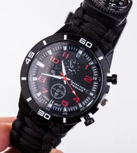 Close up view of black paracord survival watch detail showing dial and strap texture.