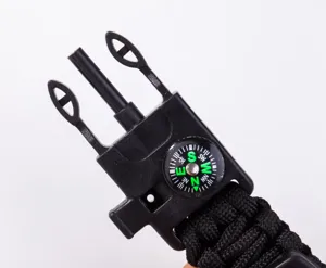 Outdoor survival paracord bracelet buckle with compass and fire starter tool, black plastic.