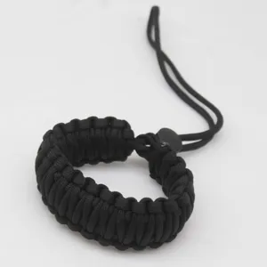 Detailed close-up of a black paracord camera wrist strap, showing tight weave and durable texture.